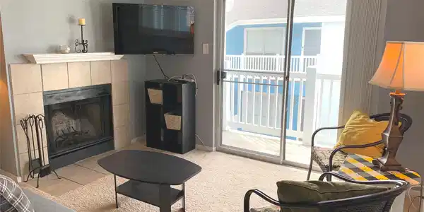 Image 3: Living room has access to a small balcony.