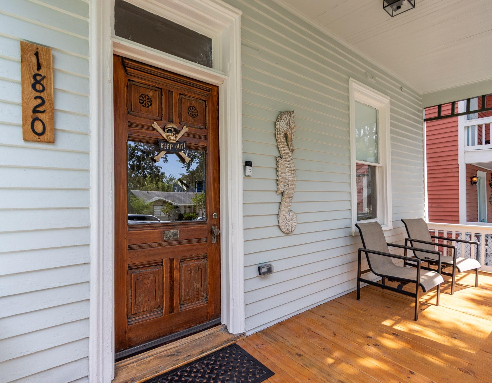 Image 2: Front door with wide transom above. Wide front por