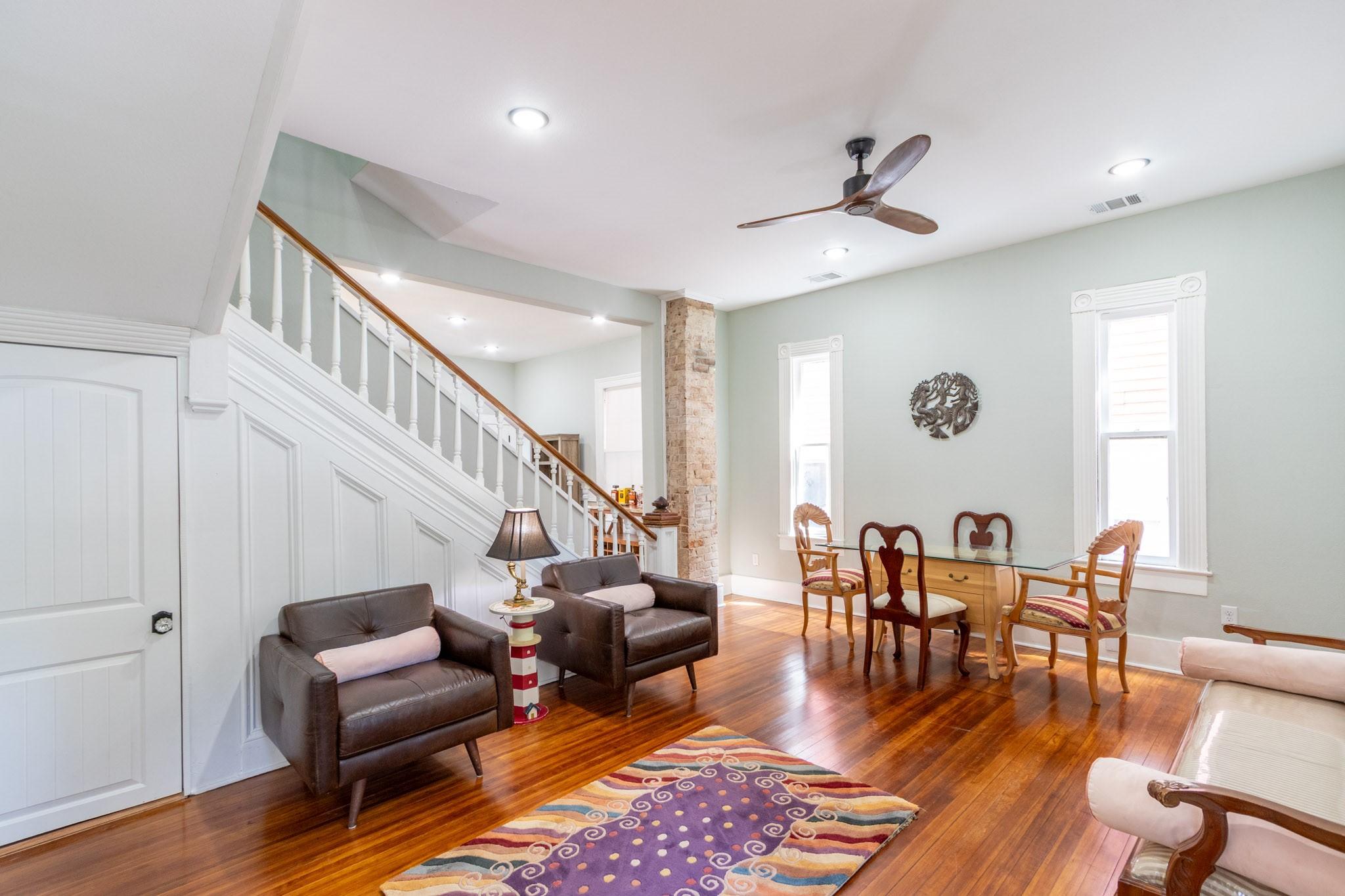 Image 3: Living area with front door to the right. Kitchen