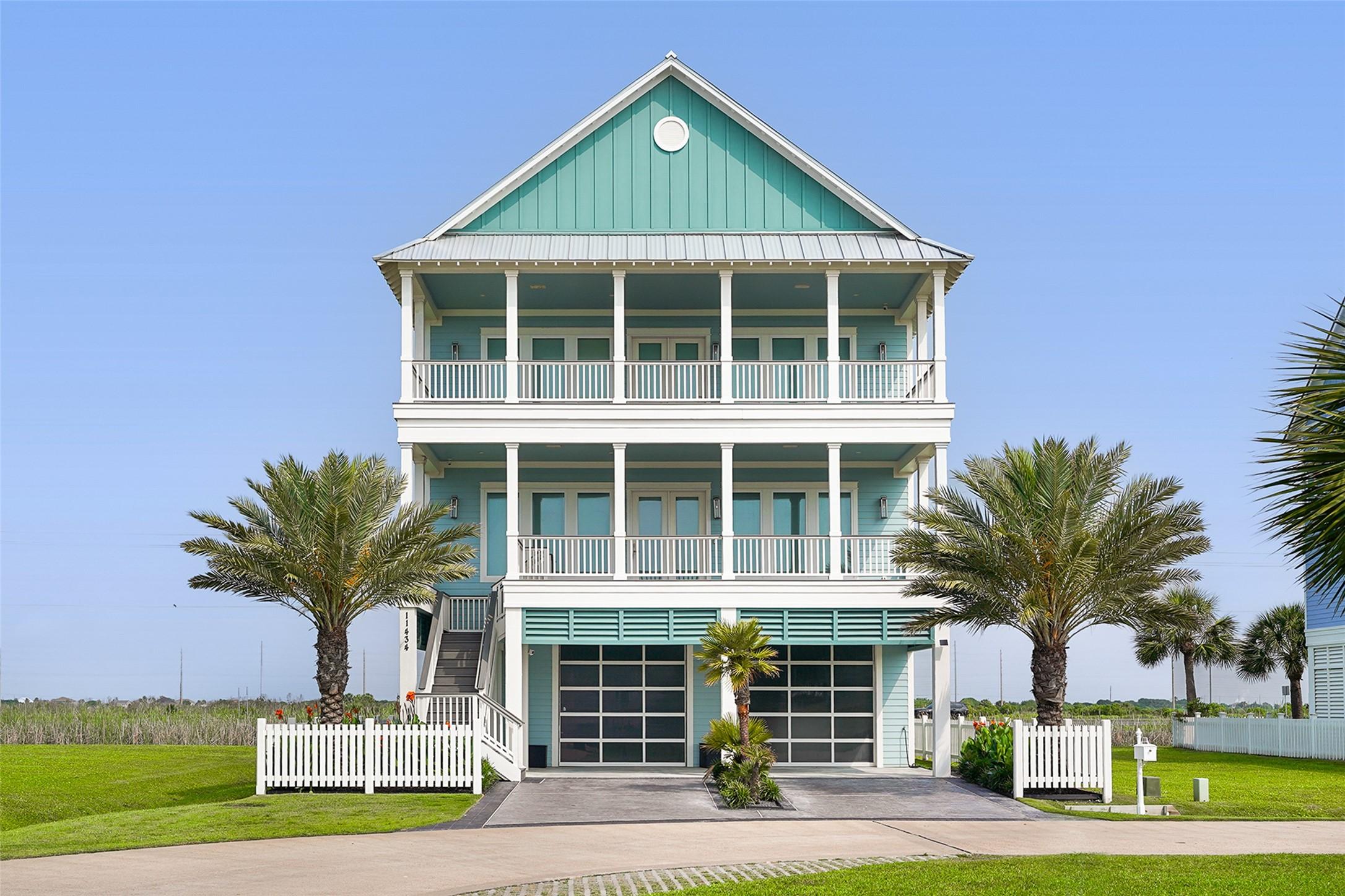 Image 2: A COASTAL-STYLE EXTERIOR with double balconies and