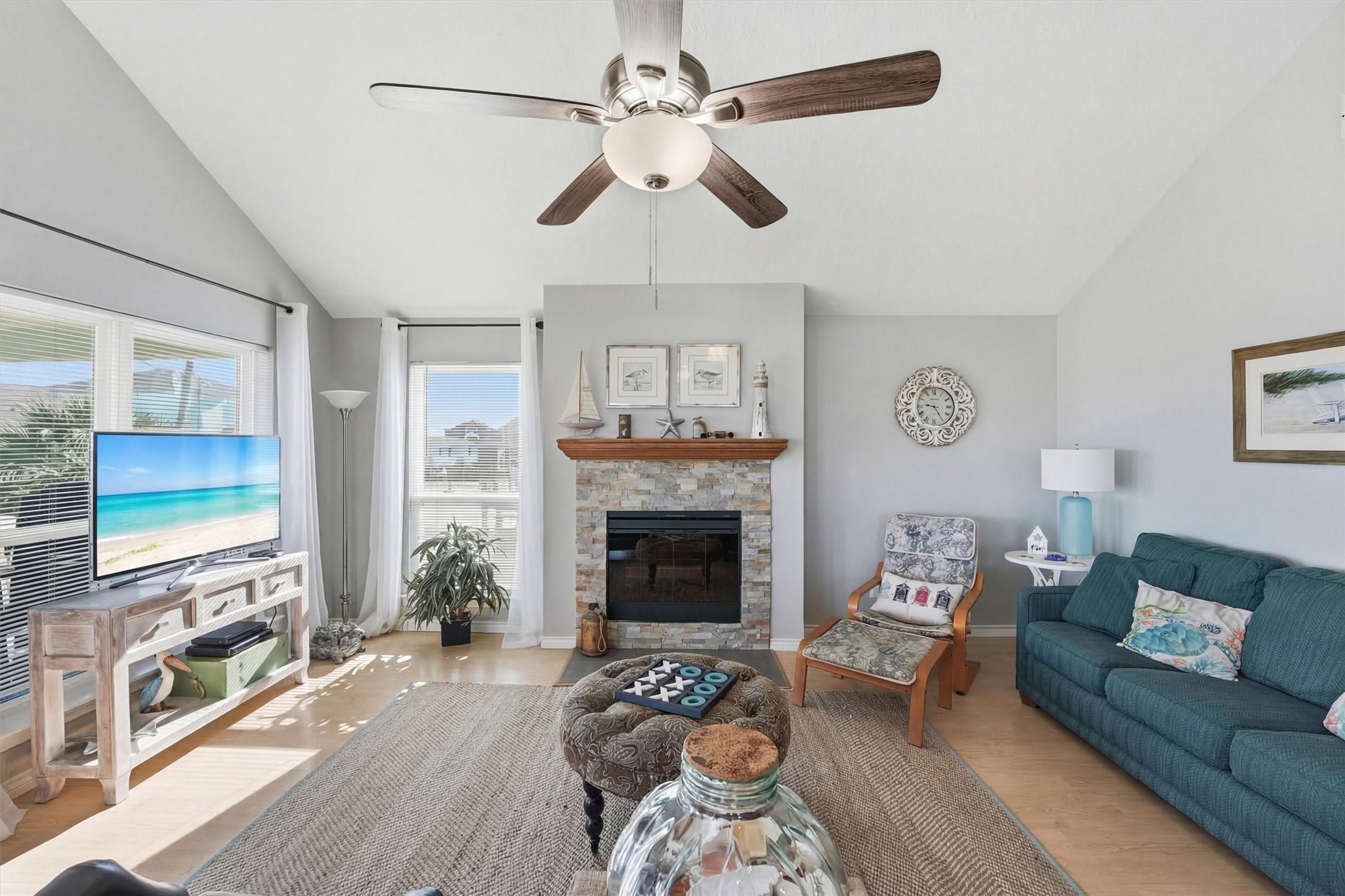 Image 3: Light-filled living area with vaulted ceilings, fi
