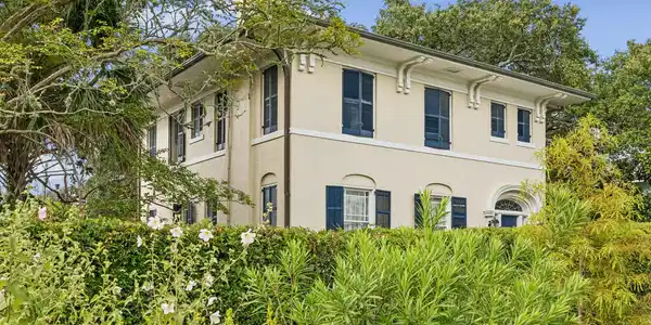 Image 2: Timeless curb appeal with hedge that provides a  p