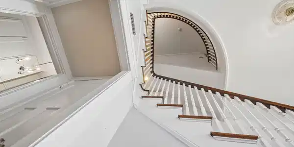 Image 4: Upward view of the stairway highlights the archite