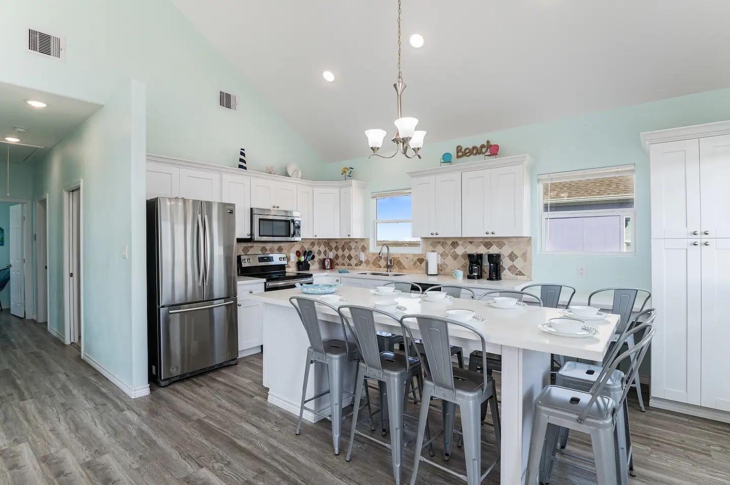 Image 4: Spacious kitchen with vaulted ceilings, featuring