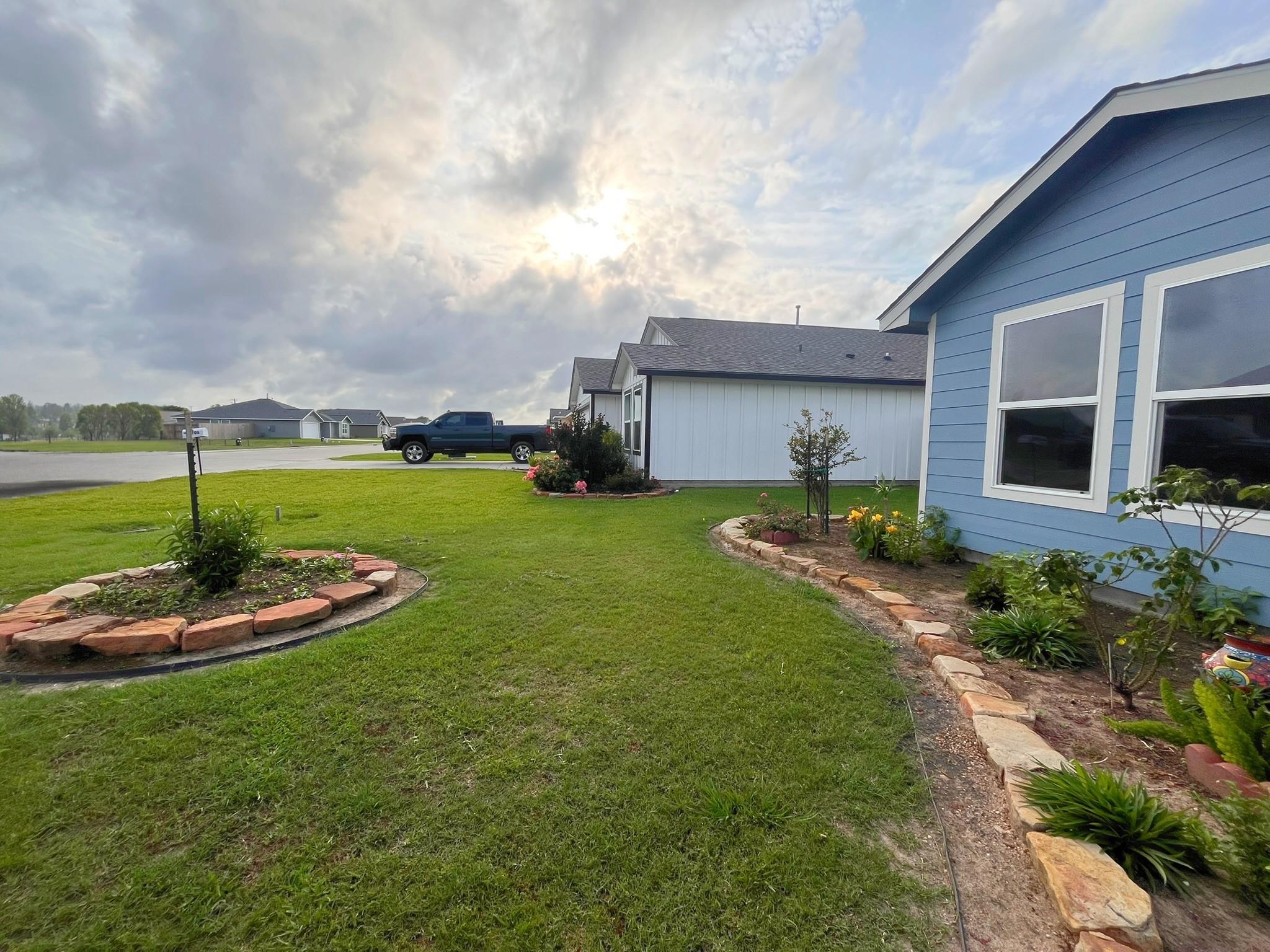 Image 2: Front view with landscaping.