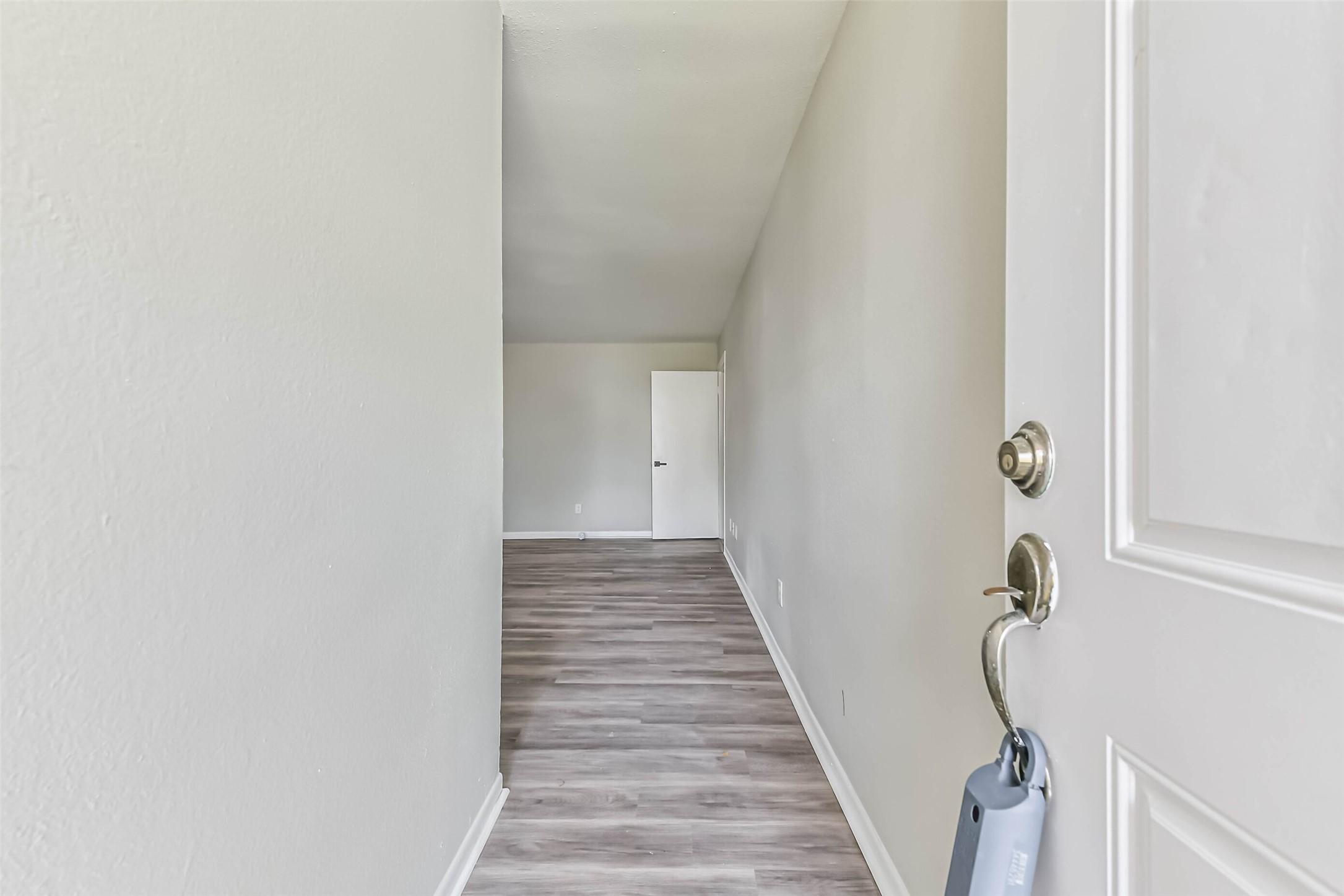 Image 2: Entryway leads you into the living room.