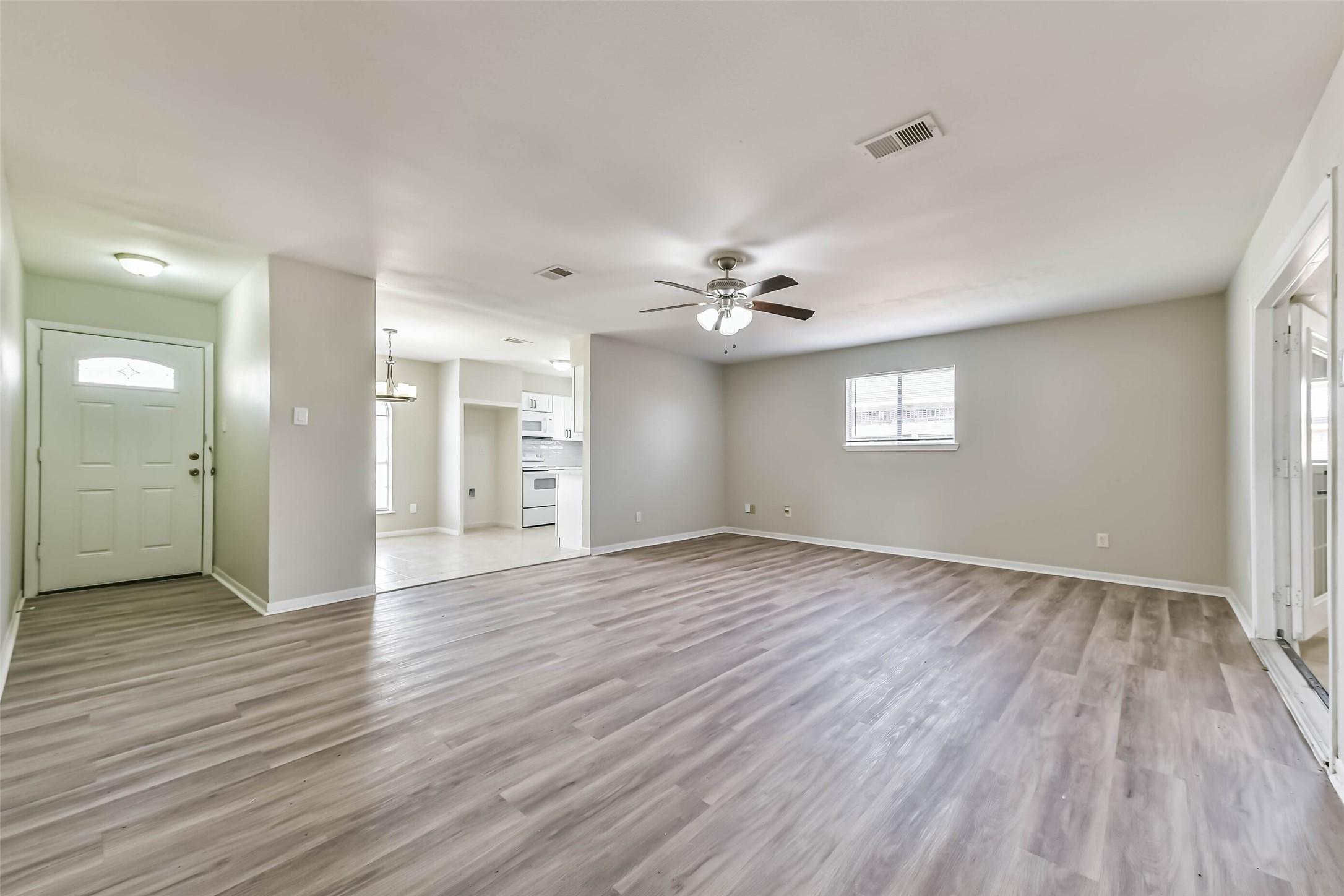 Image 3: View of living room and front door.