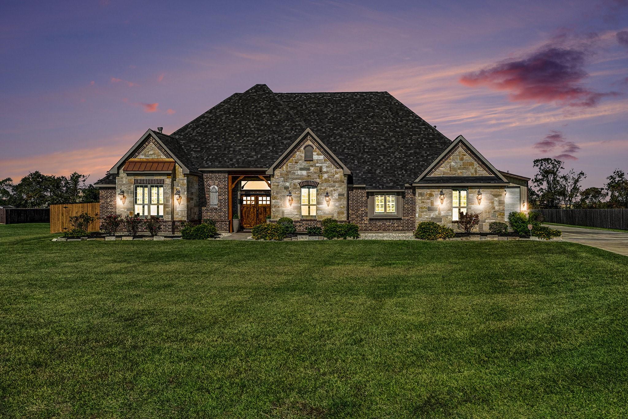 Image 1: Street view of home at sunset