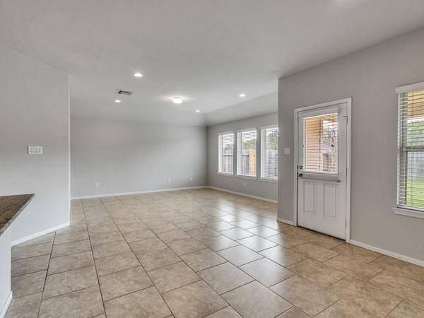 Image 4: Spacious, light-filled room with neutral walls and