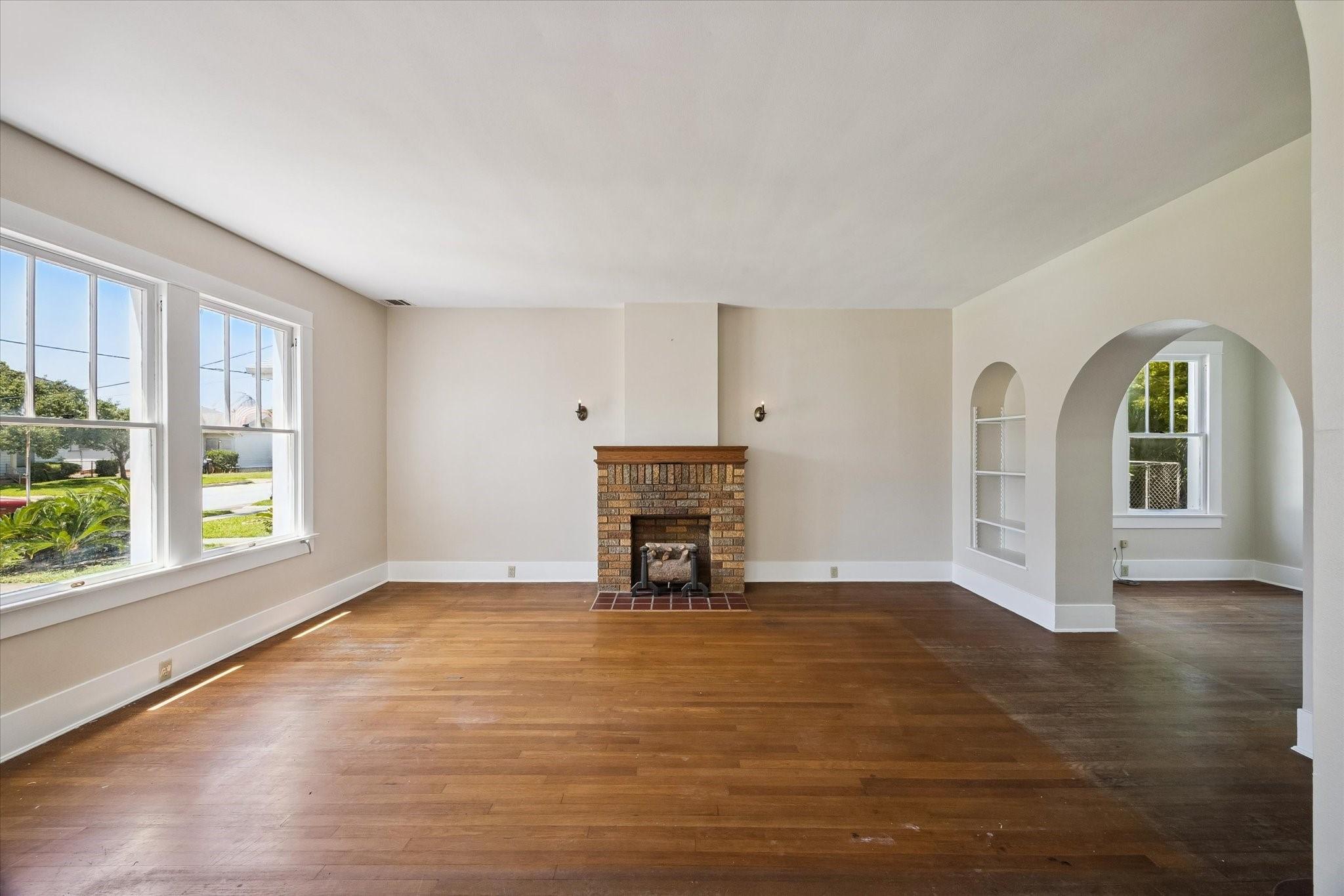 Image 3: This inviting living room features hardwood floors