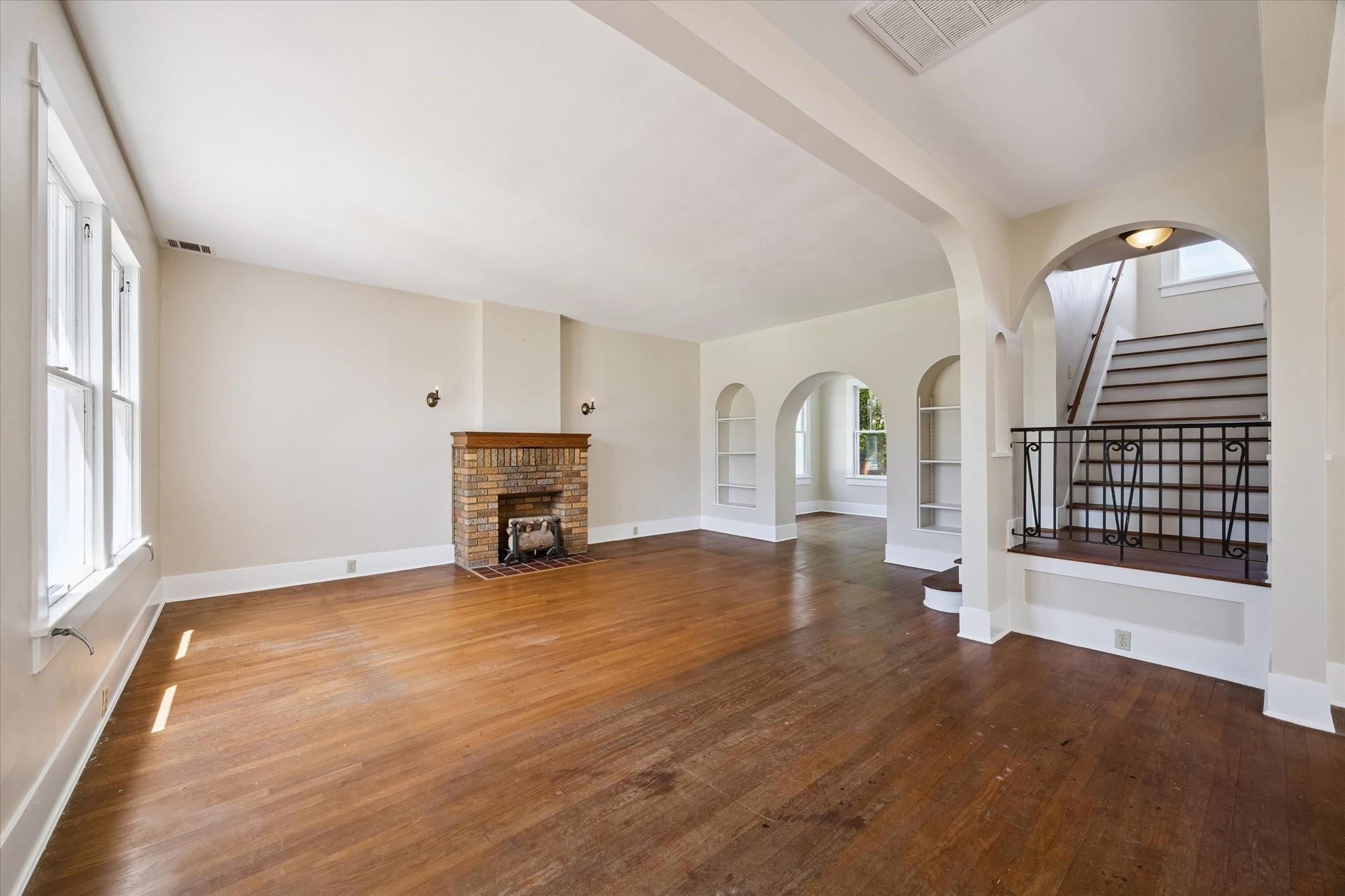 Image 4: This spacious living area features hardwood floors