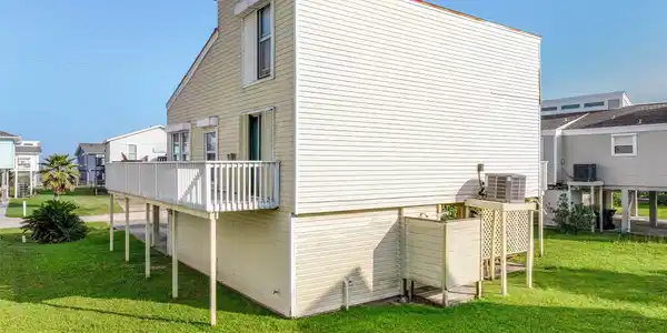 Image 4: The rear exterior of the home, featuring an elevat
