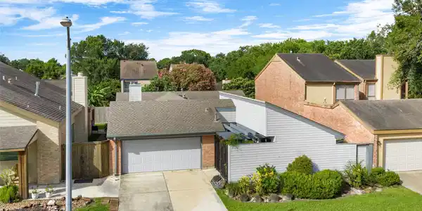 Image 2: Ariel view of 16630 Neumann Dr, the treelined gree