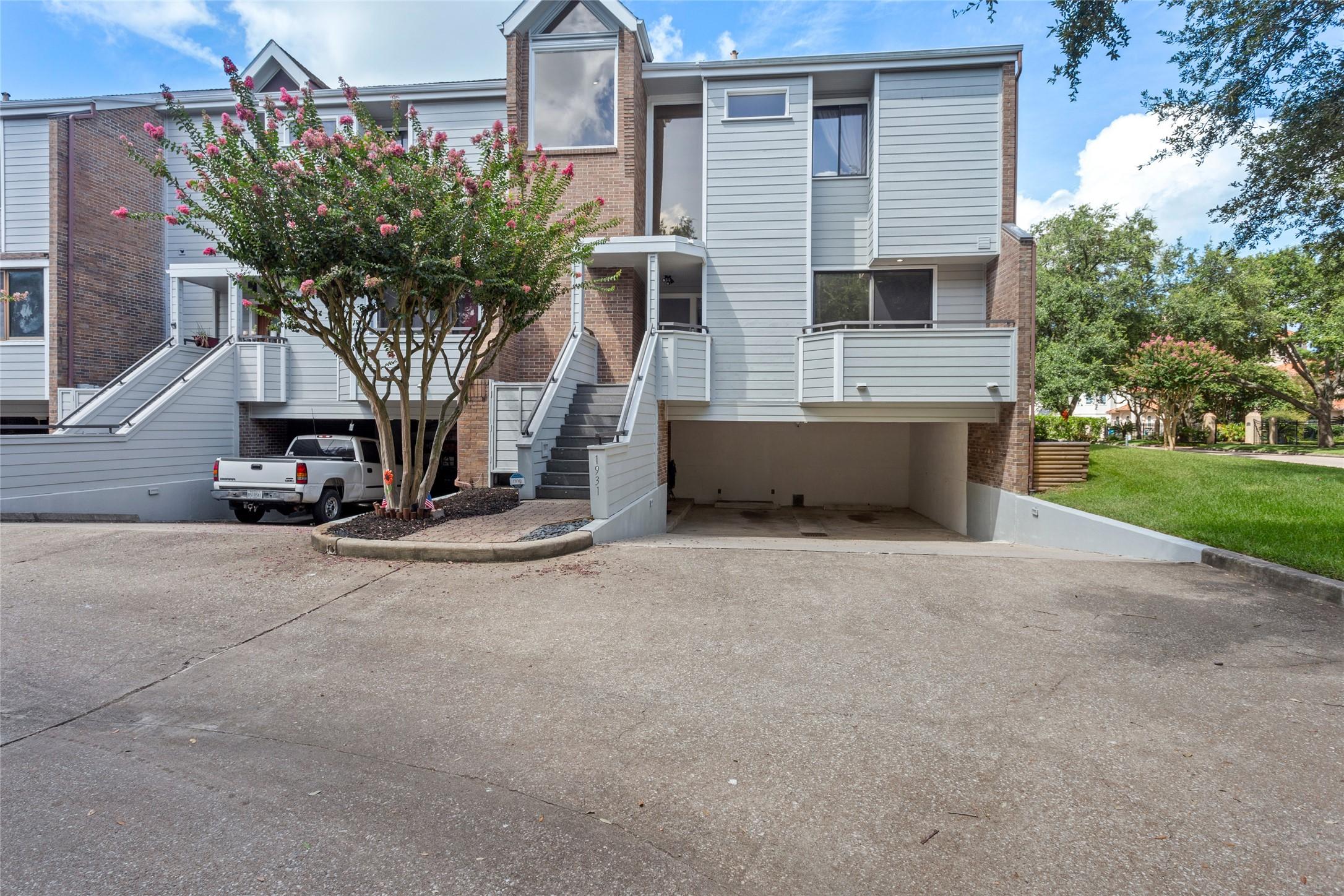 Image 4: Front of the home showcasing a balcony off the kit