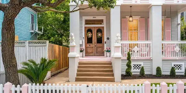Image 2: Front exterior with white picket fence, steps to v