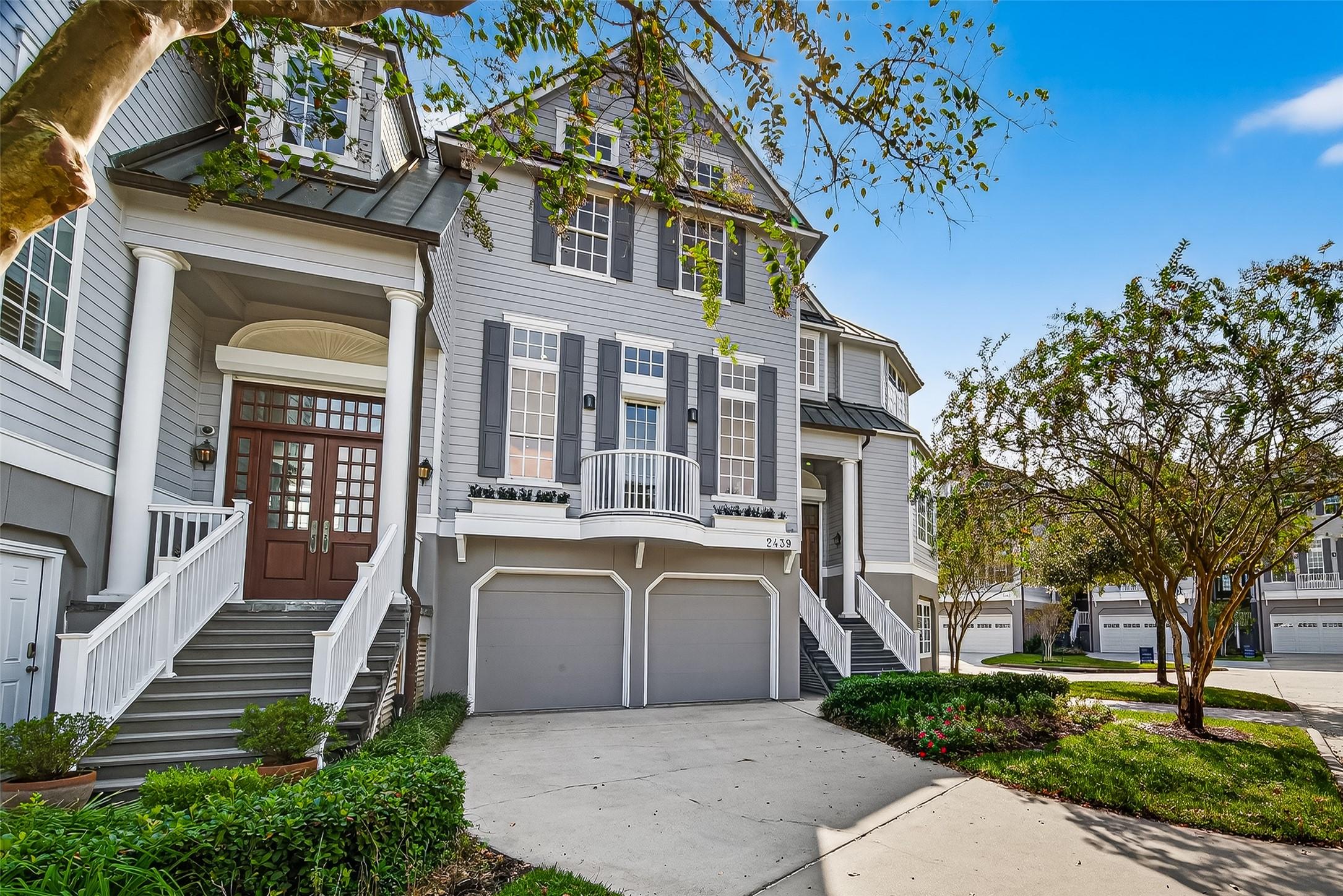 Image 1: Front elevation of the townhome. 2 car garage with