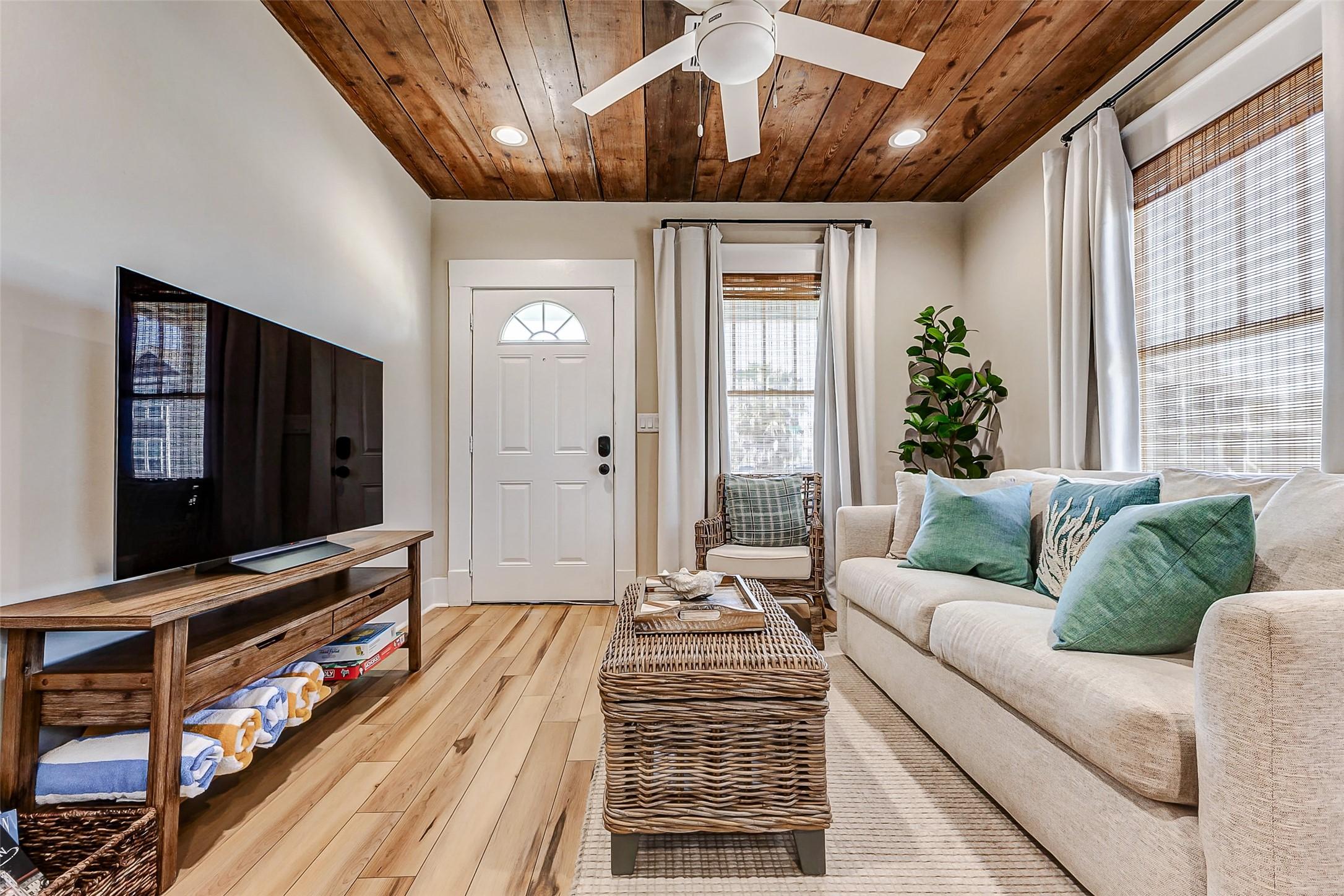 Image 3: The living room features beautiful original wood c