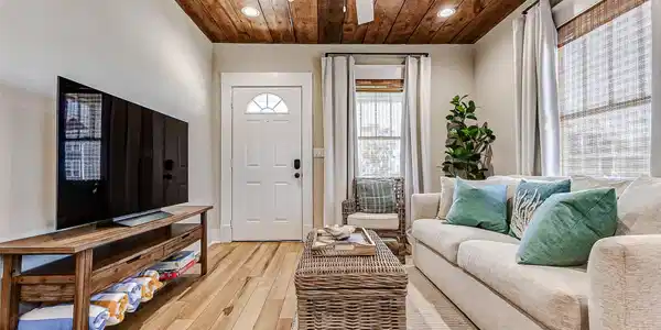 Image 3: The living room features beautiful original wood c