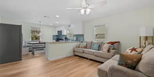 Image 4: This photo showcases a bright, open-concept living