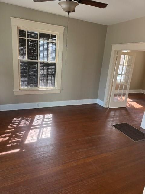 Image 2: Living room has wood flooring, a ceiling fan and t