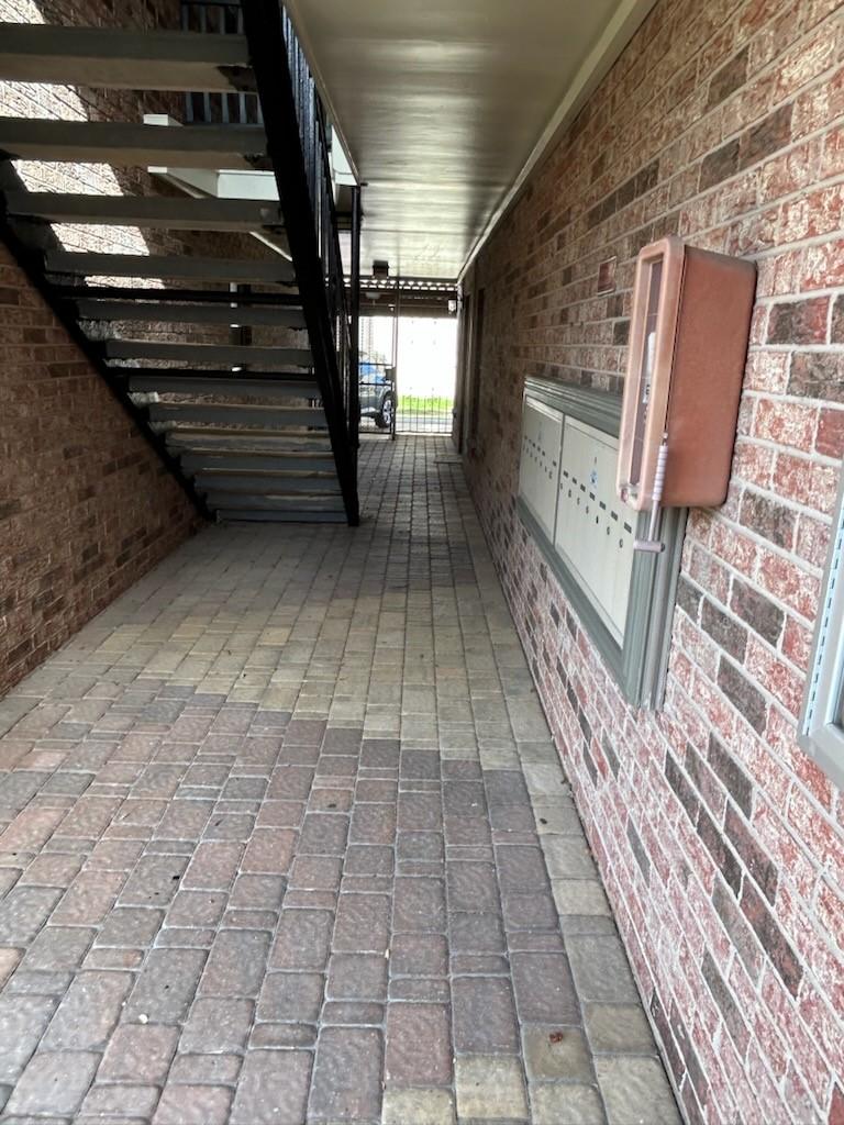 Image 4: Covered walk-way to the carports and alley with th