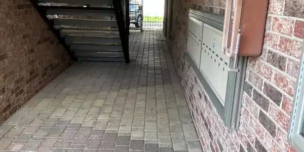 Image 4: Covered walk-way to the carports and alley with th