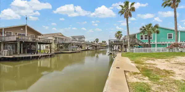 Image 2: Charming waterfront homes line a serene canal, acc