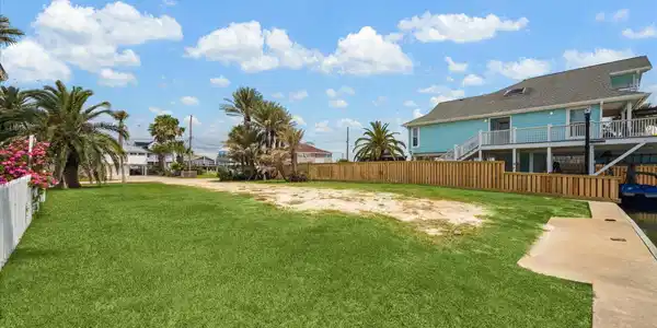 Image 3: Spacious waterfront lot with lush greenery and pal