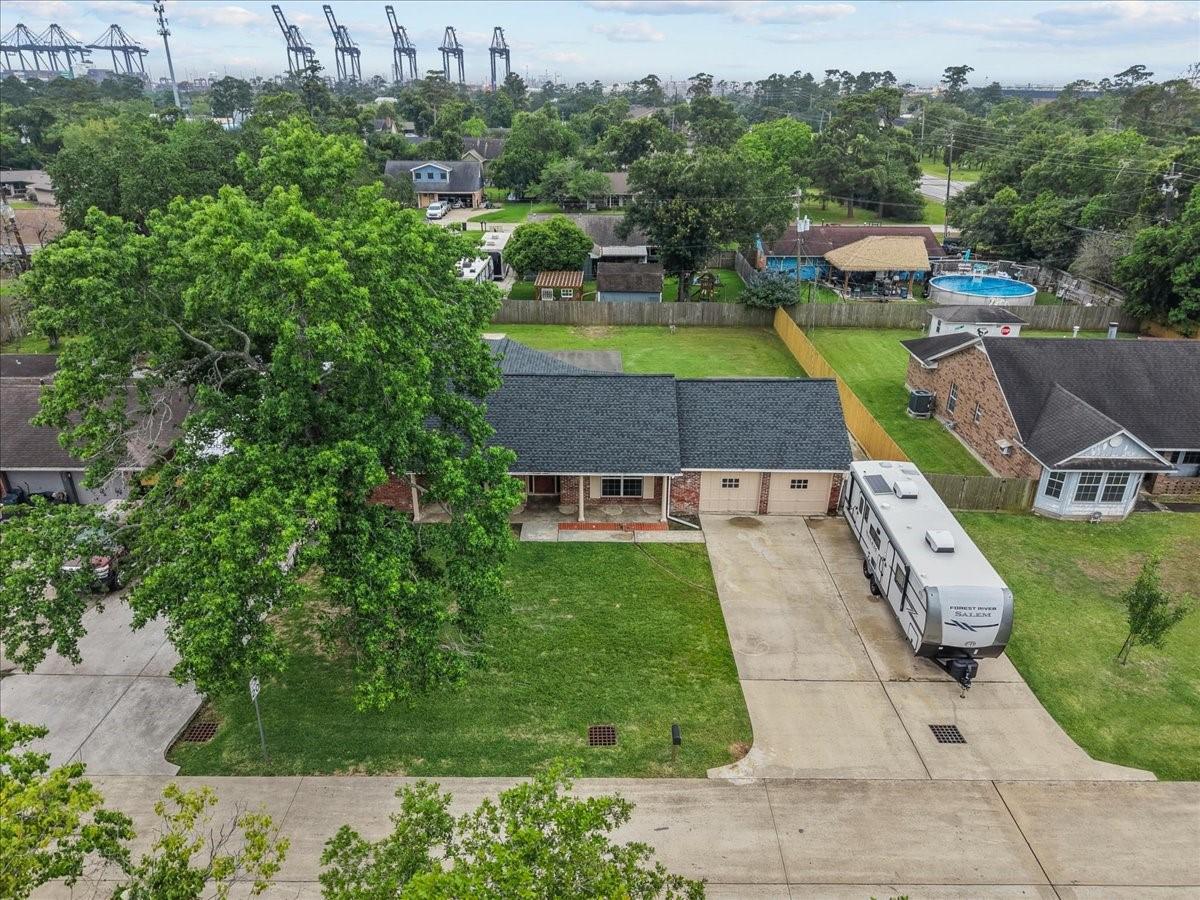 Image 2: Aerial view showcasing generous parking space, lar