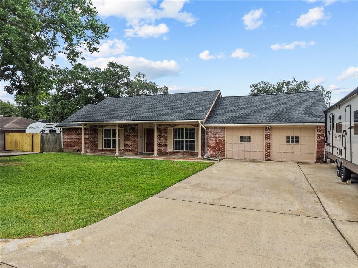 Image 3: Charming brick exterior with covered front porch a