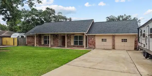 Image 3: Charming brick exterior with covered front porch a