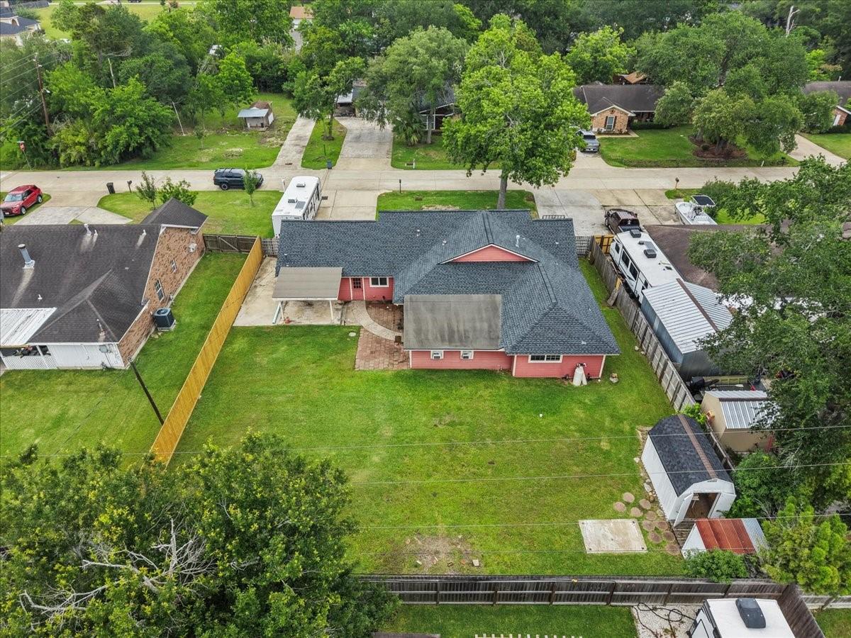 Image 4: Rear aerial view featuring oversized backyard, pat