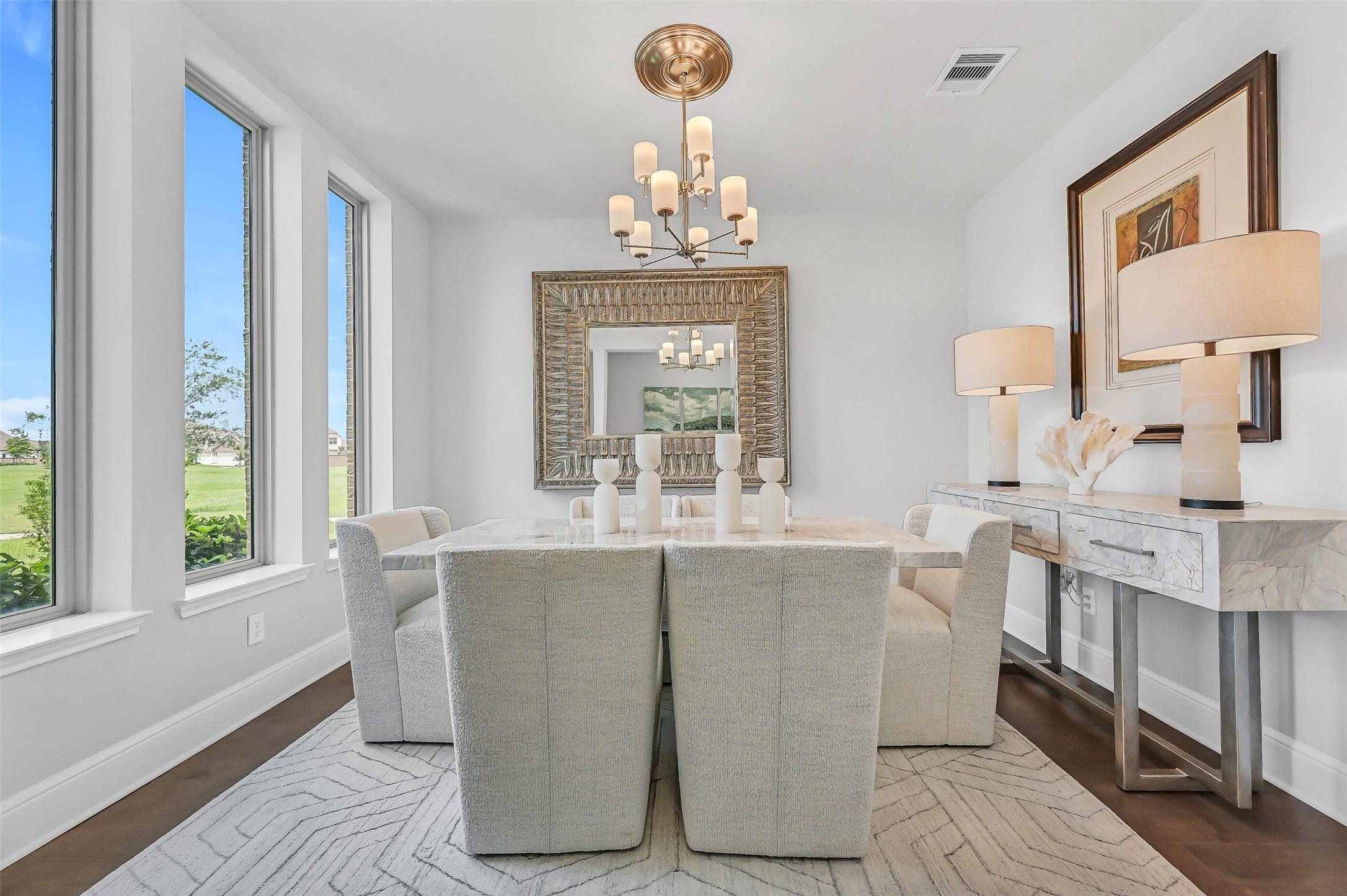 Image 2: Just off the foyer, the formal dining room is bath