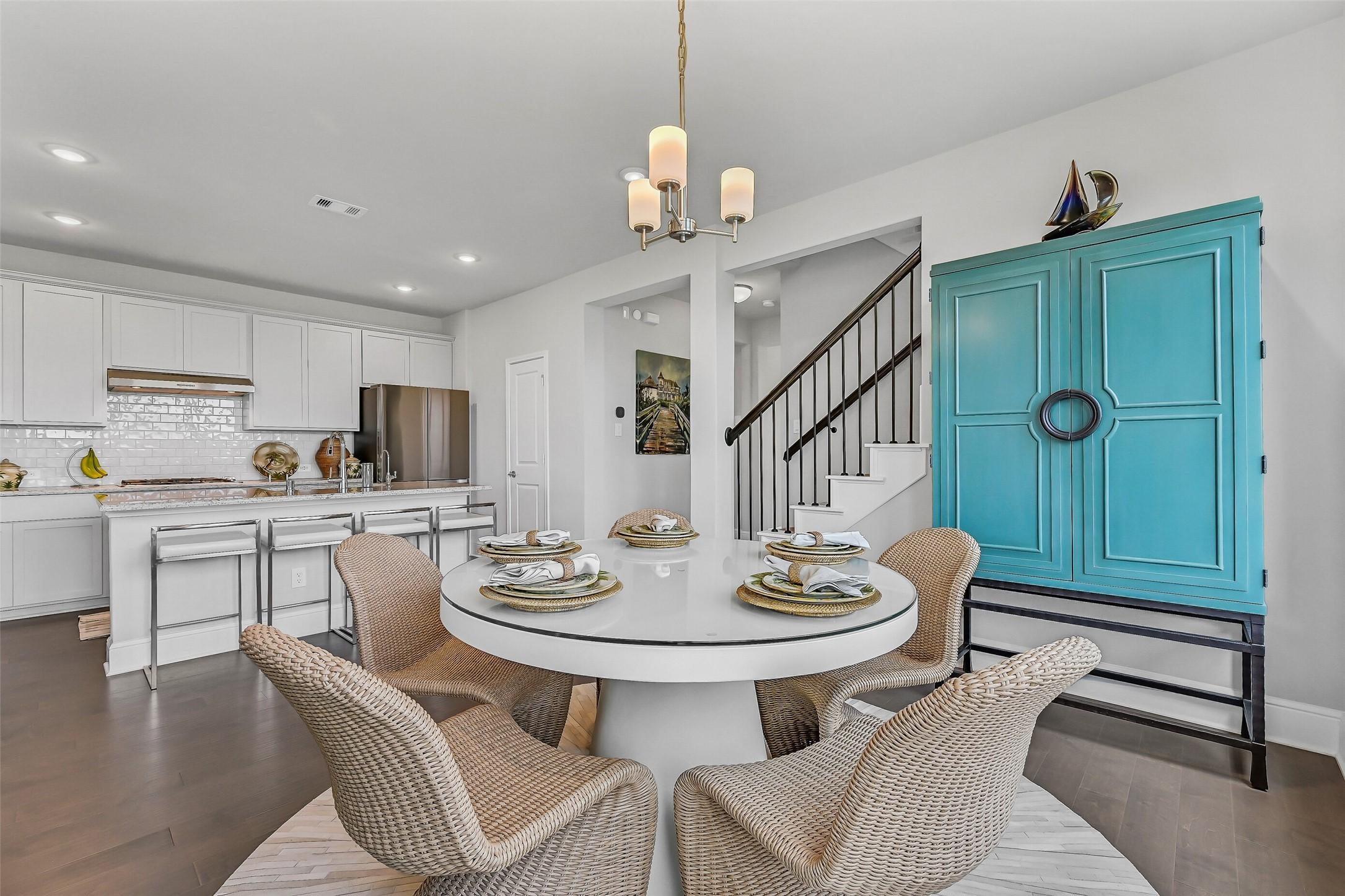 Image 3: The breakfast area is filled with natural light fr
