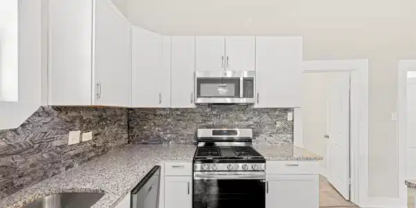 Image 4: this stunning kitchen showcases updated white cabi
