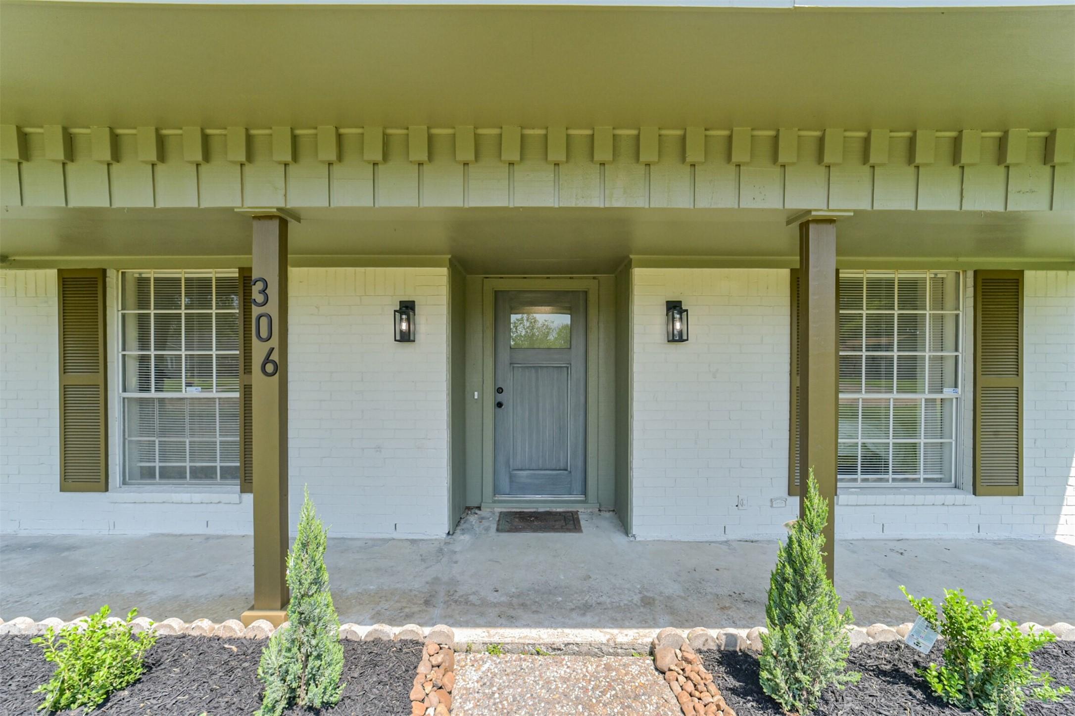 Image 2: The front porch offers plenty of room for seating,