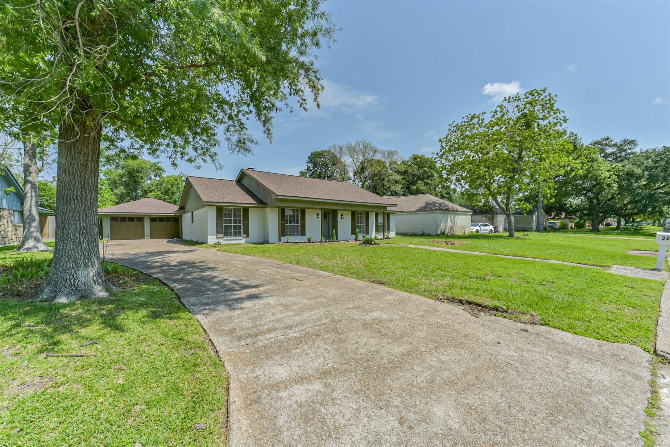Image 3: This home features an extended driveway with ample