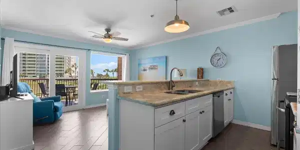 Image 3: The open-concept kitchen and living area makes it