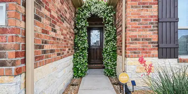 Image 4: Charming entrance with a brick exterior, elegant a