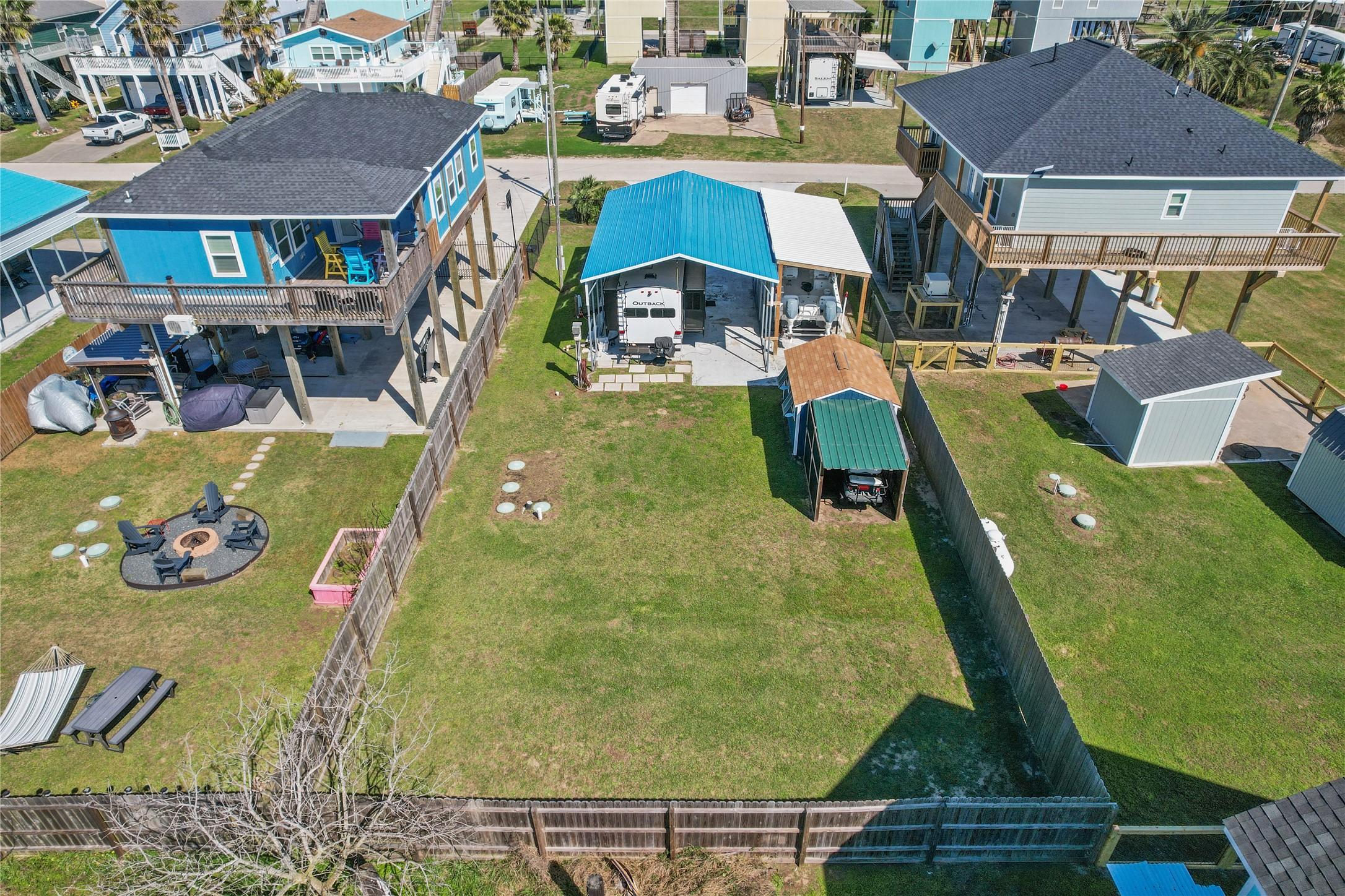 Image 2: This photo showcases a fenced backyard with a spac