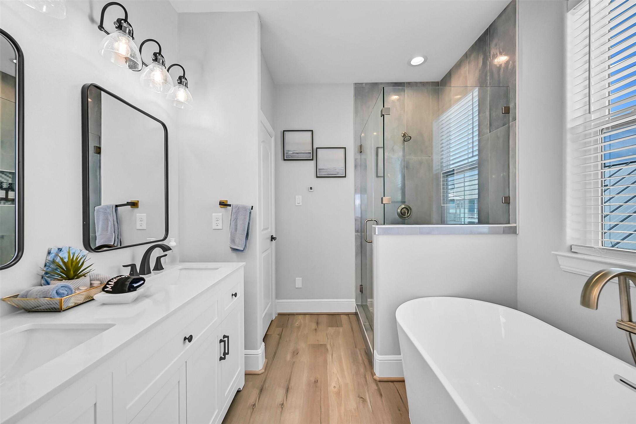 Image 4: The primary bath feels straight out of a boutique