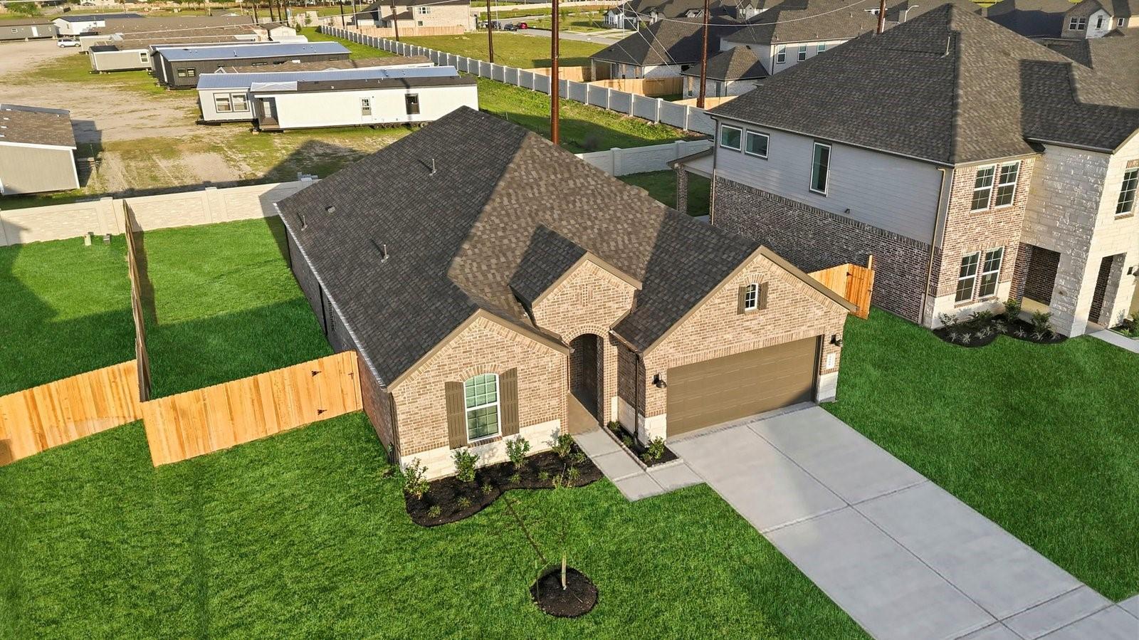 Image 2: An aerial view of the newly built one story home w