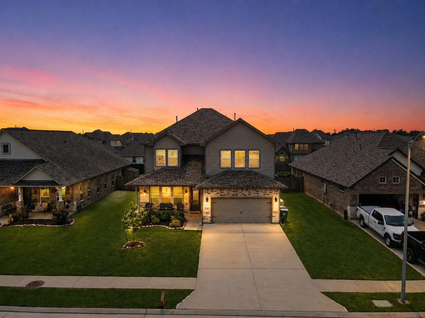 Image 1: Stunning dusk-to-dawn exterior showcasing exceptio