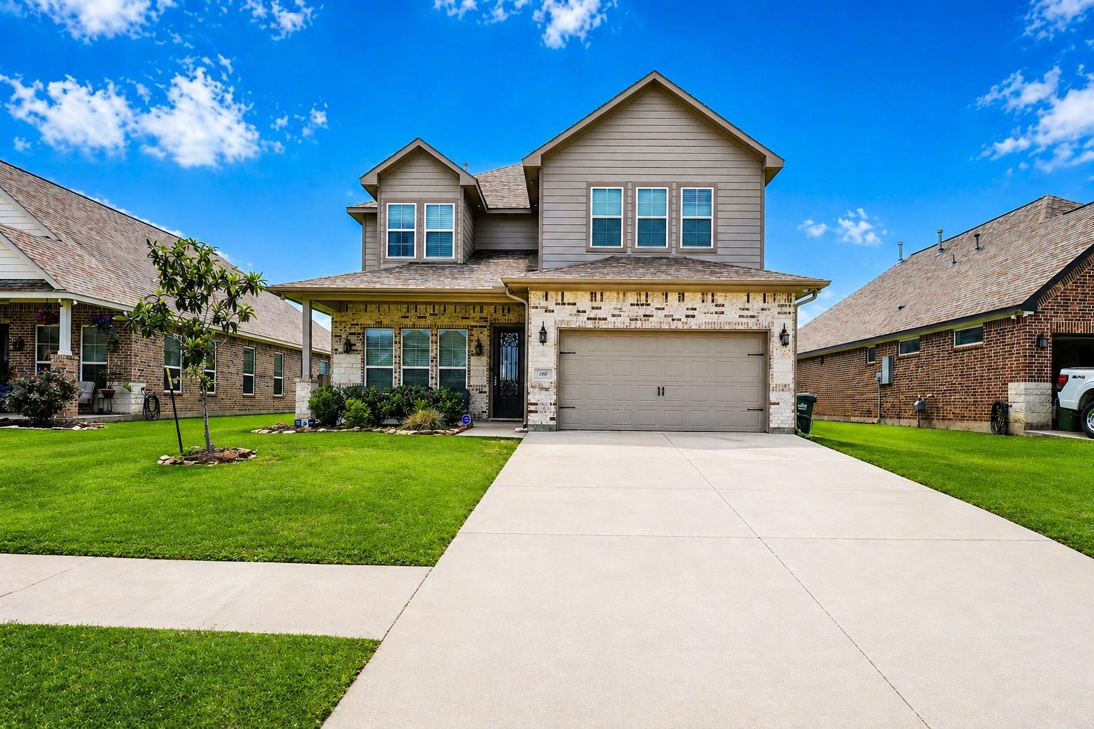Image 2: This is a two-story, modern suburban home with a b