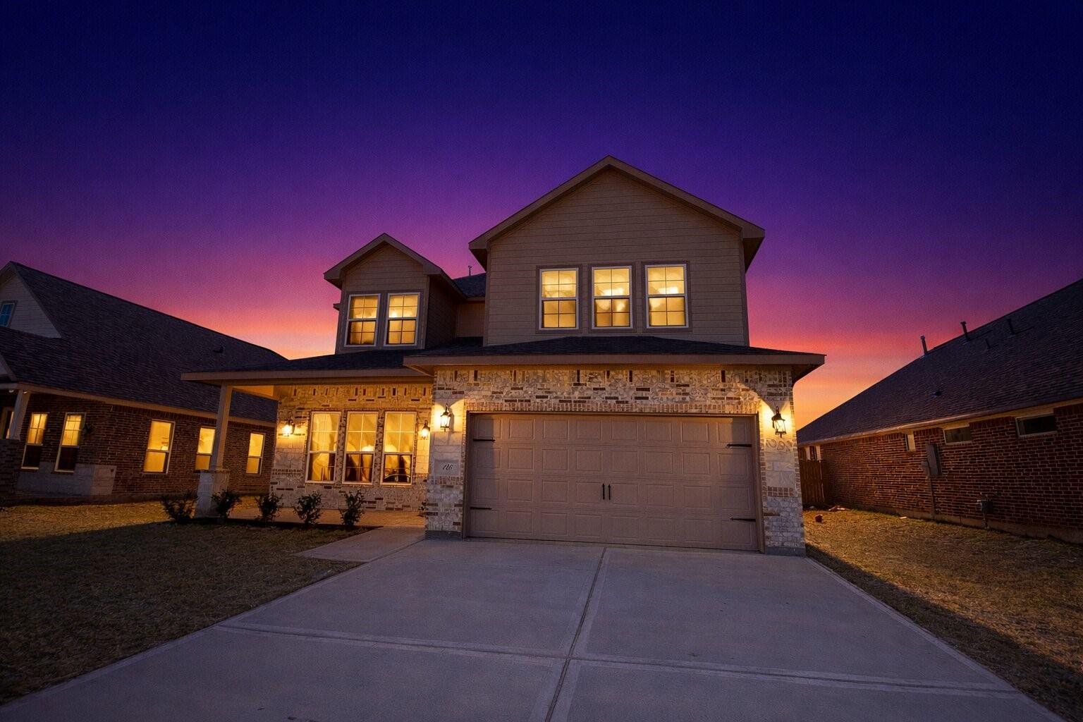 Image 3: Dusk-to-dawn photos showcase this stunning 5-bedro