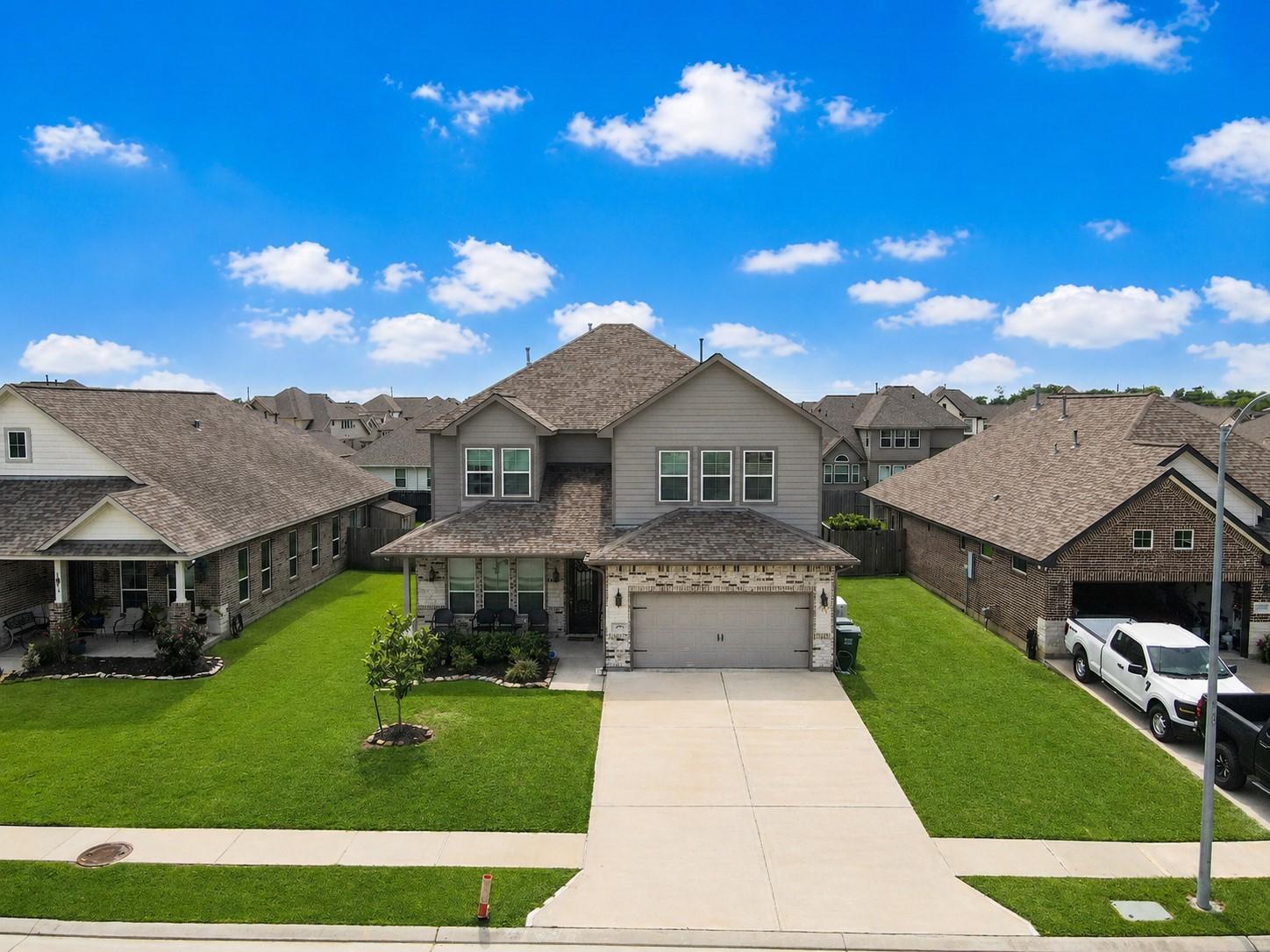 Image 4: This photo features a modern two-story home with a