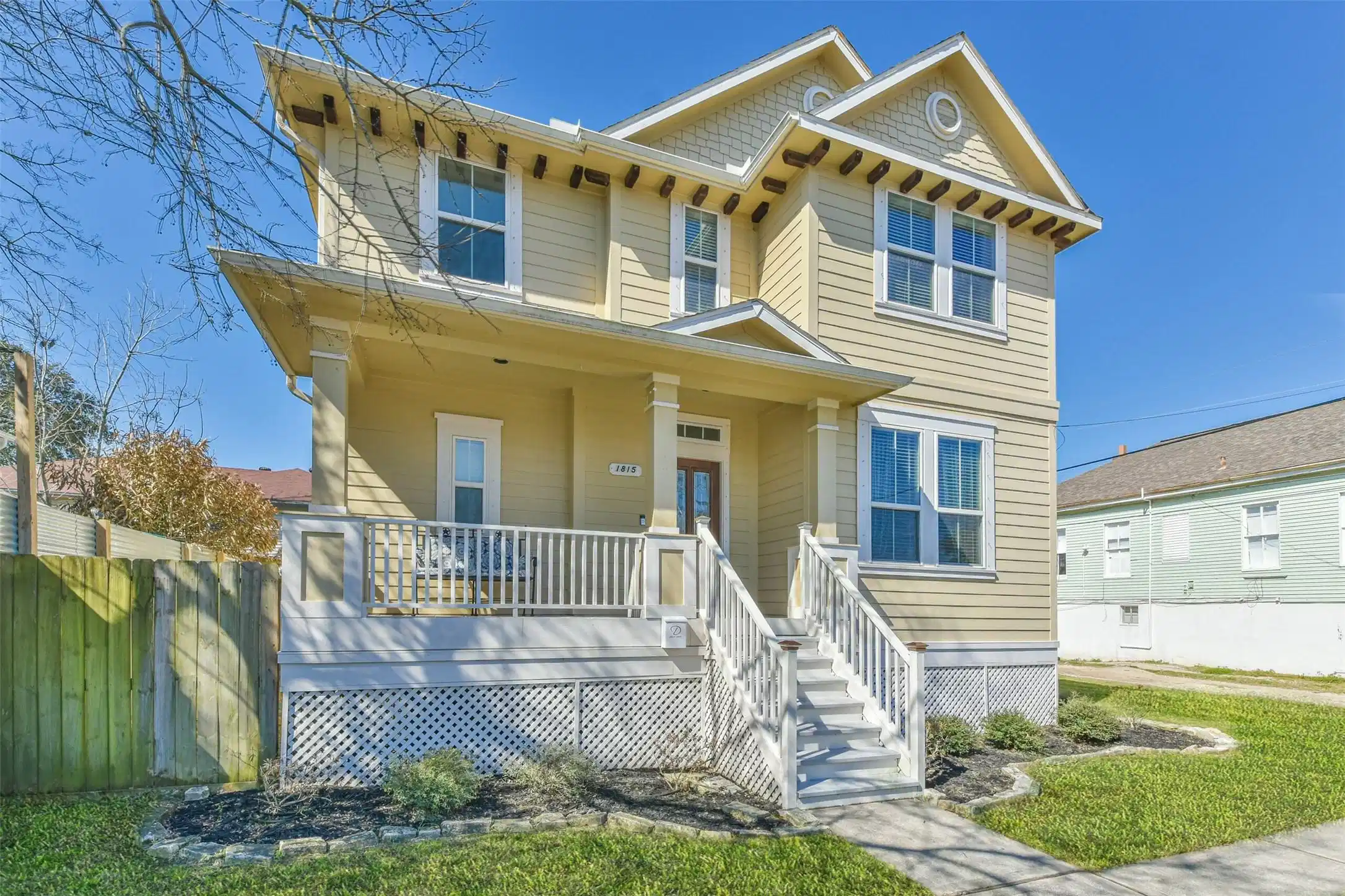 Image 1: This is a charming two-story, beige house with a w