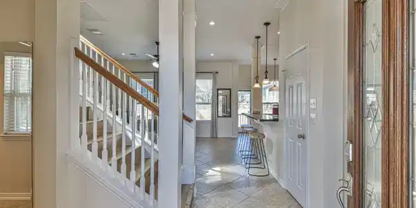 Image 3: This inviting entryway features a wooden door with