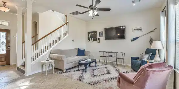 Image 4: Bright and inviting living room with tiled floors,