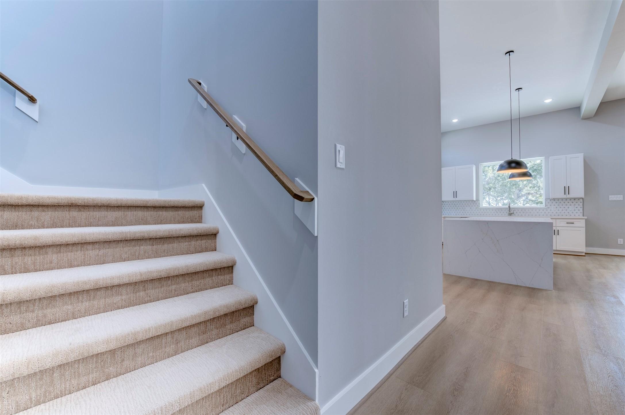 Image 2: This photo features a modern, open-concept home wi